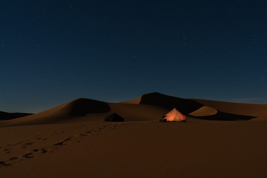 a tent in the desert - romantic desert camp