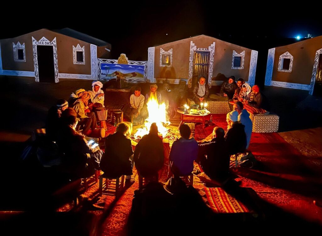 group of people playing music around the fire