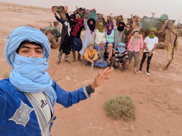 group of people and camels in the desert