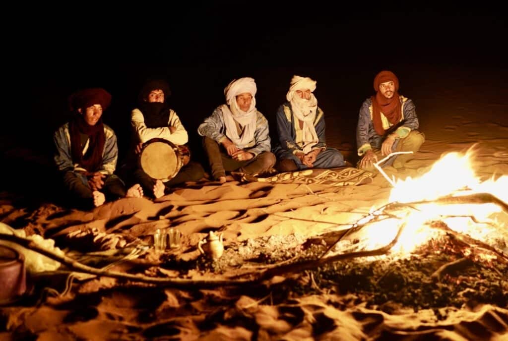 Desert nomads playing music around the fire