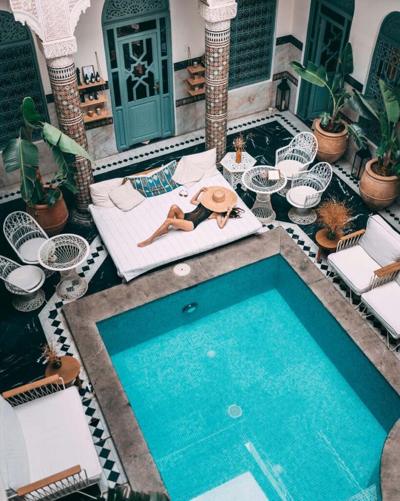 A woman by the pool in a Moroccan riad