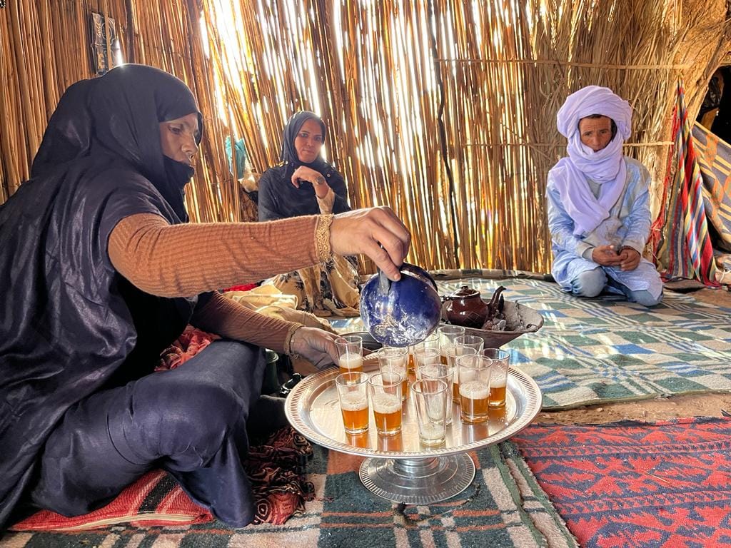 woman pouring tea in a nomad home